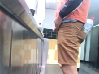 Guys urinals taking leak...